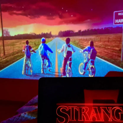 Castle window view showing kids on bikes at sunset, Stranger Things scene projection